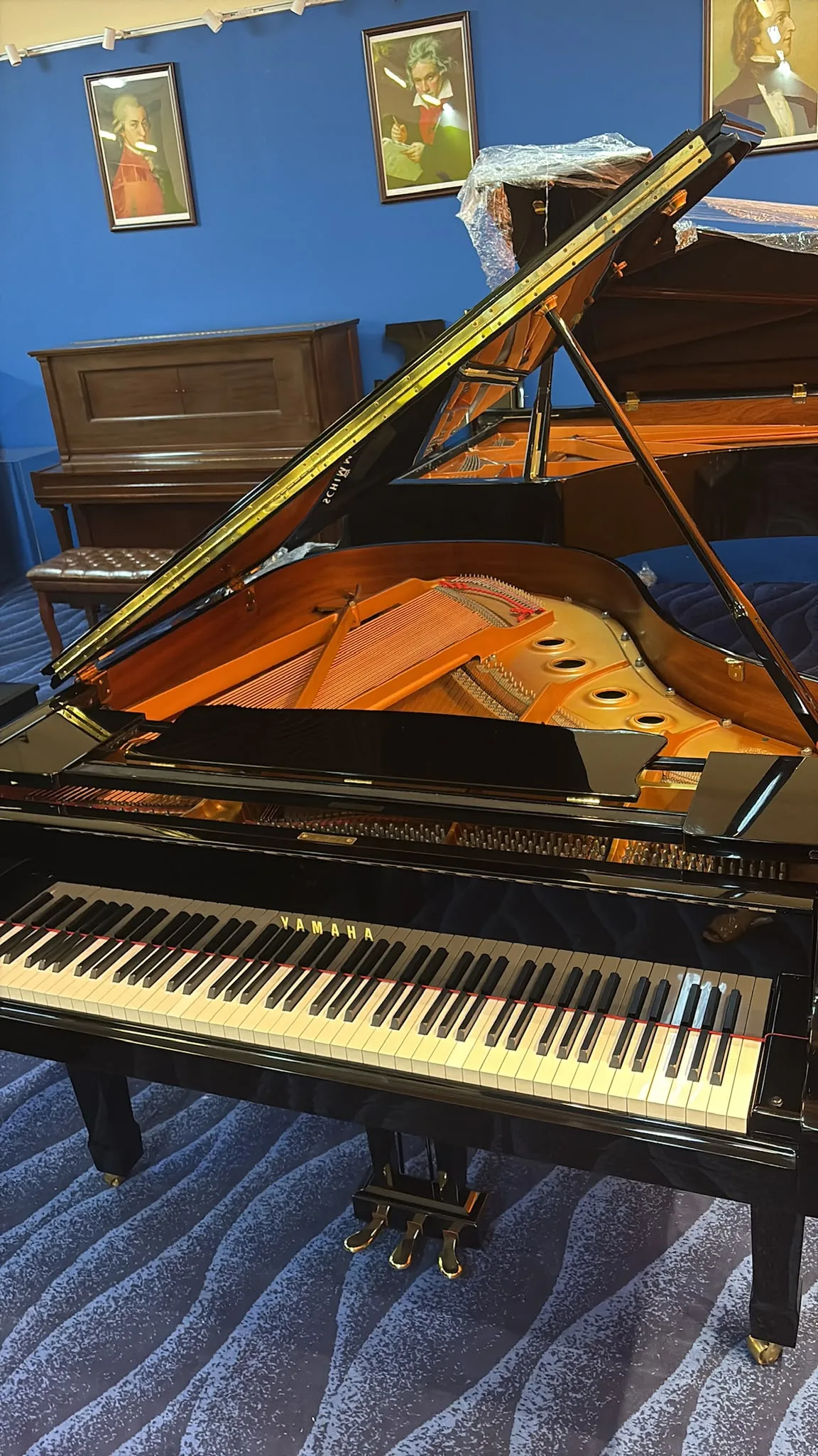 A Yamaha grand piano with its lid raised in the Music Companion viewing gallery