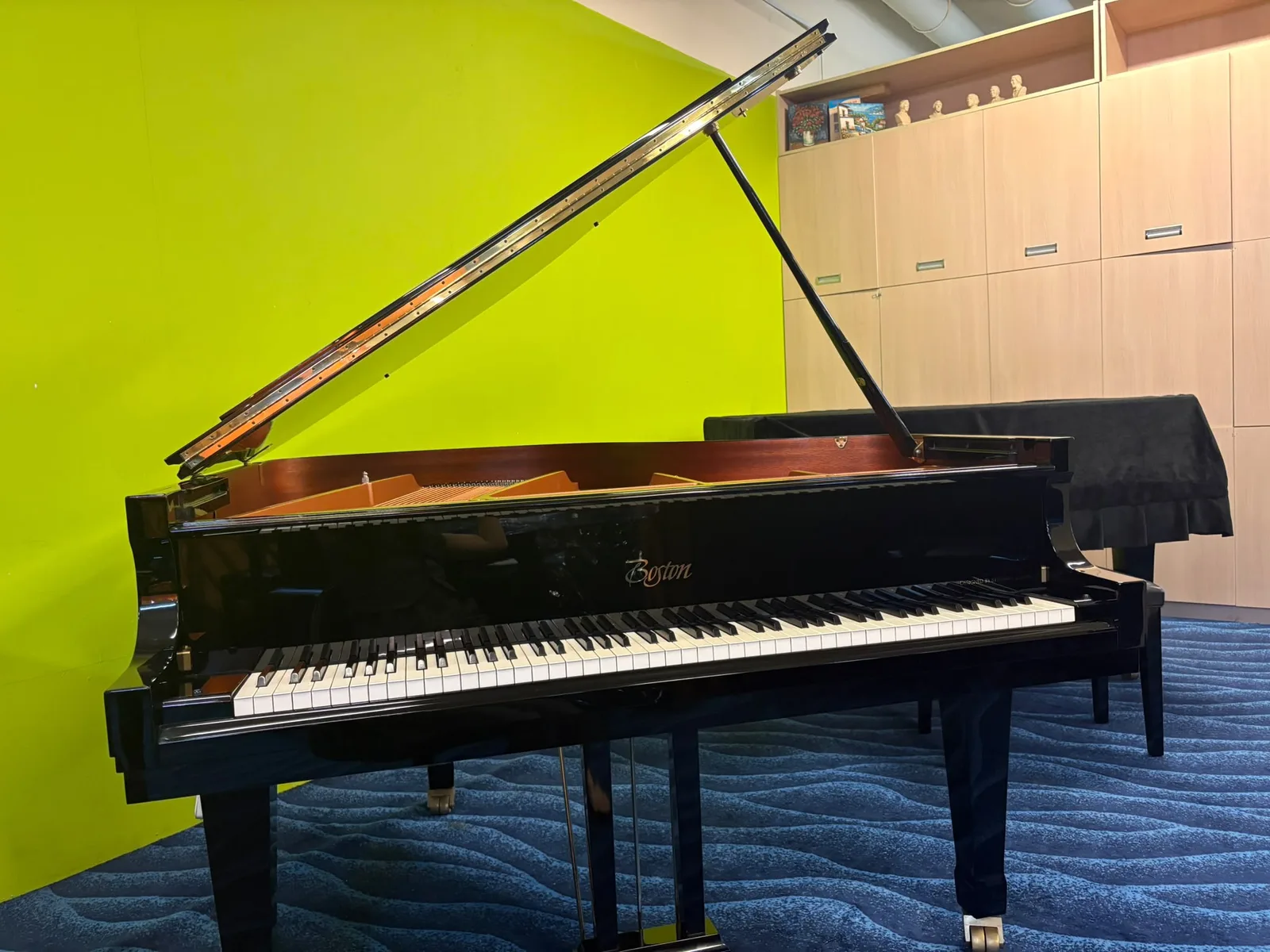 A Boston grand piano with the lid raised in the Music Companion viewing gallery